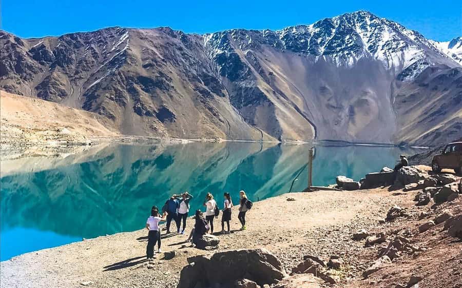Full-Day Embalse del Yeso & Hot Springs Tour from Santiago - A cheese platter and Chilean wine with a mountain view