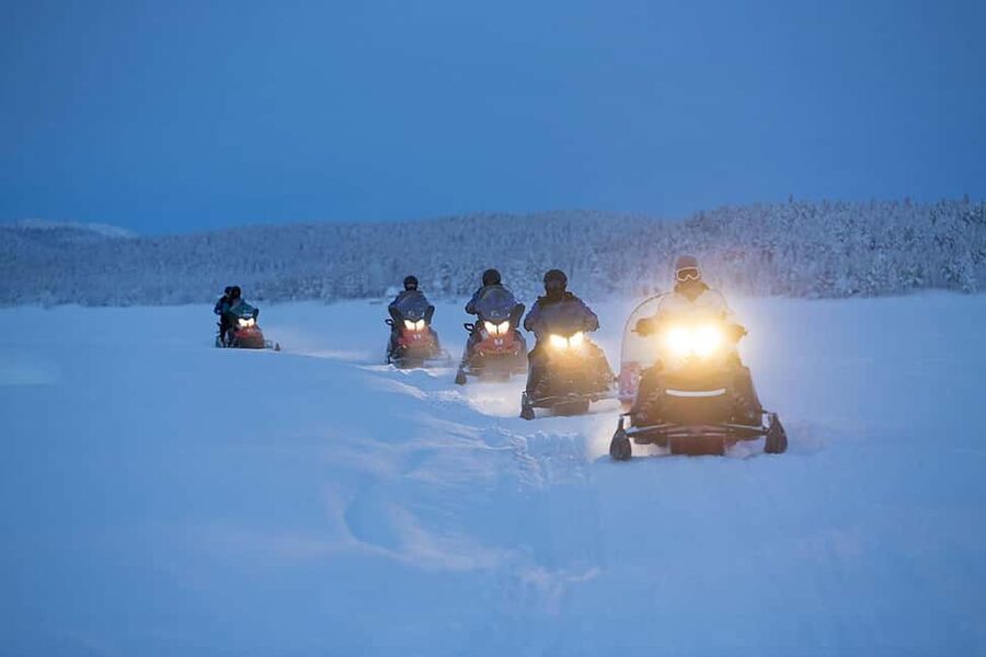 Kiruna: Overnight Snowmobile Tour with Dinner and Sauna - Riding beside the Torne River