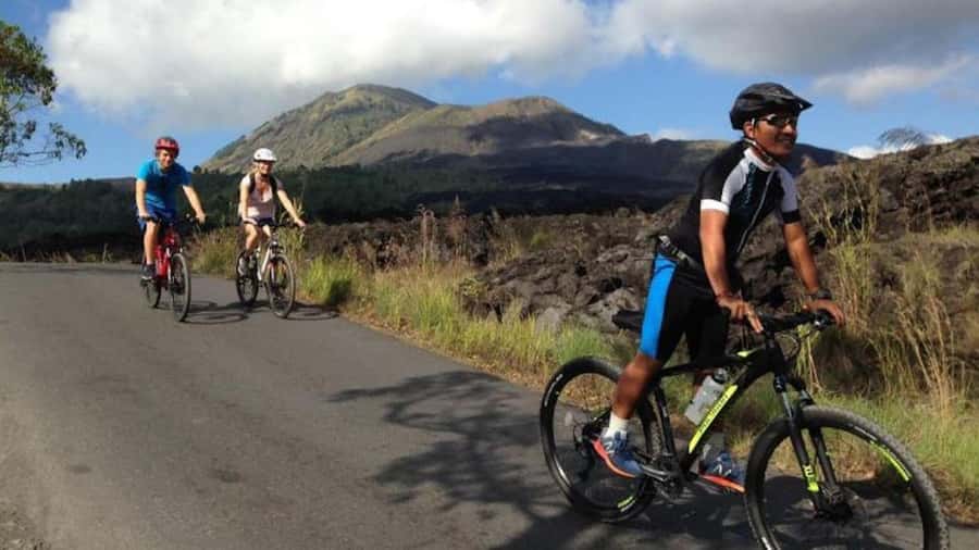 Mount Batur: Black Lava Cycling Tour w/ Natural Hot Spring - Riding through villages and toward Lake Batur
