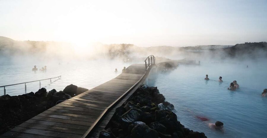Steam lifting off a geothermal lagoon in the Icelandic lava field at dusk
